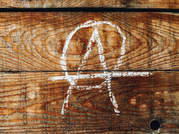 Anarchist symbol on wooden wall written in chalk