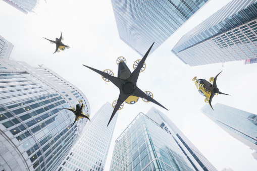 Four eVTOLs-Electric Vertical Take Off is flying between the buildings and skyscrapers.. (3d render)