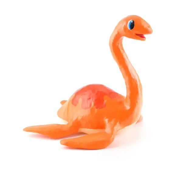 Photo of Cute dinosaur toy isolated on white background, paper mache style