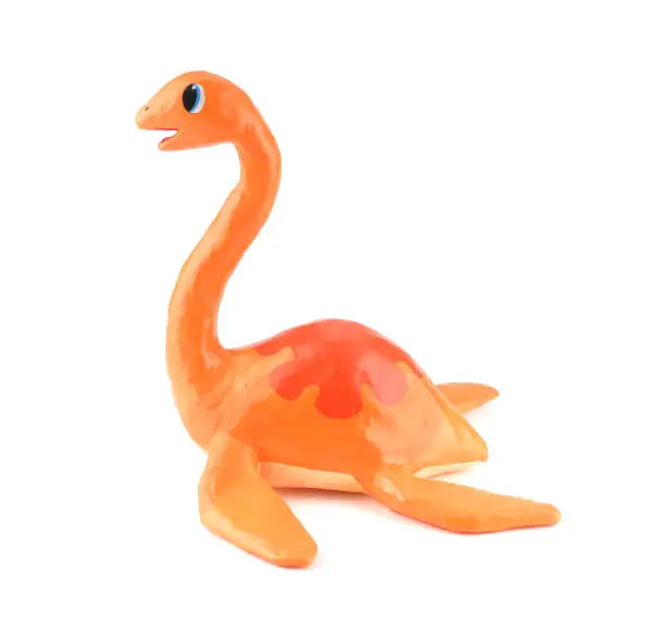 Photo of Cute dinosaur toy isolated on white background, paper mache style