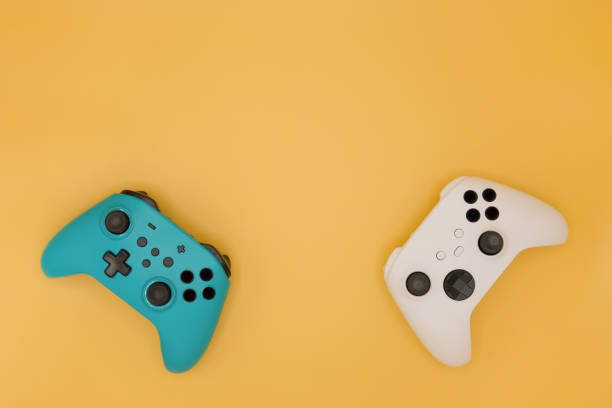 istock Joysticks gaming controller isolated on pastel yellow background, Video game console developed Interactive Entertainment 1399199203