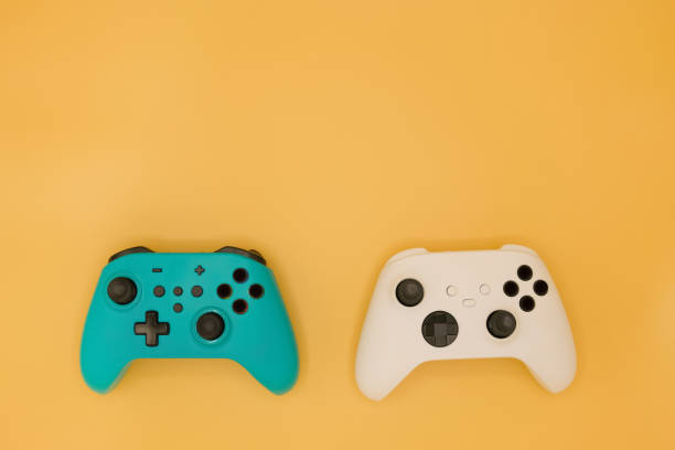 istock Joysticks gaming controller isolated on pastel yellow background, Video game console developed Interactive Entertainment 1399199204