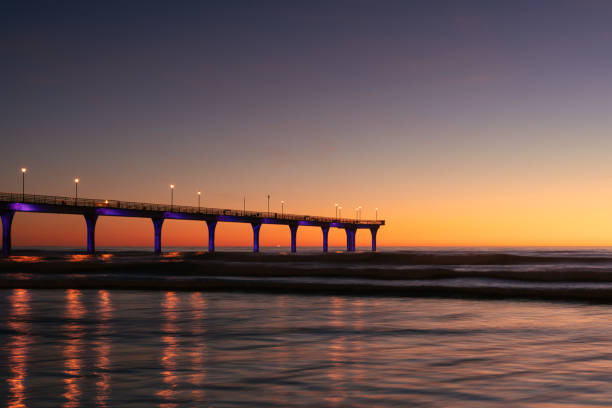 New Brighton Pier during colorful sunrise morning. Christchurch city, New Zealand stock photo