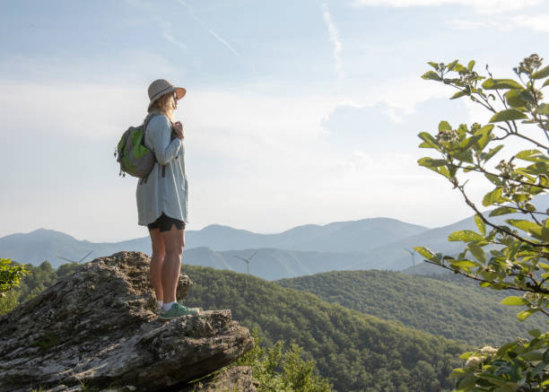 istock Female hiker relaxes at viewpoint, at sunrise 1399201948