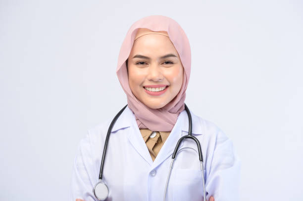 istock Female muslim doctor with hijab over white background studio. 1399202058
