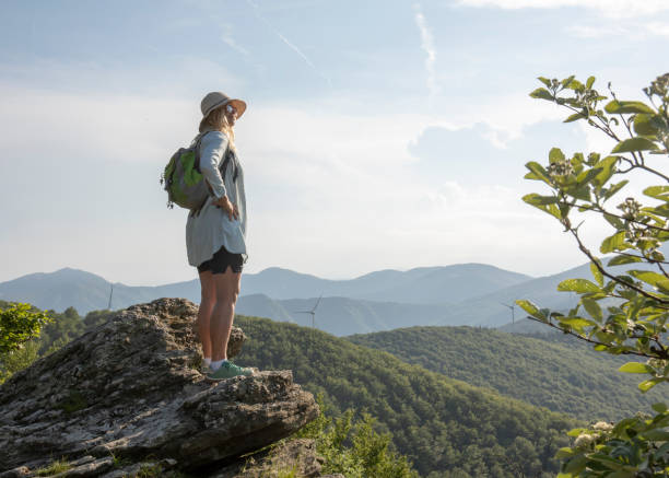 istock Female hiker relaxes at viewpoint, at sunrise 1399202082