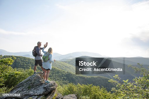 istock Mature hiking couple relax at viewpoint 1399202868