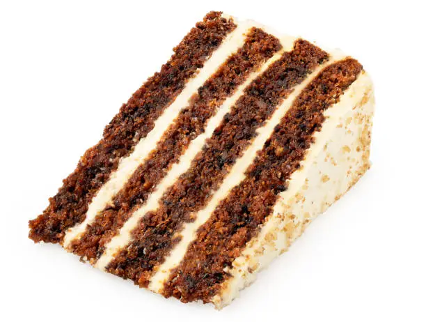 Slice of carrot cake with cream cheese filling and frosting isolated on white. Lying down.