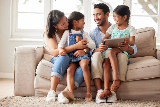 istock Content happy family smiling while using a digital tablet and choosing what to watch at home together on a sofa 1399203626