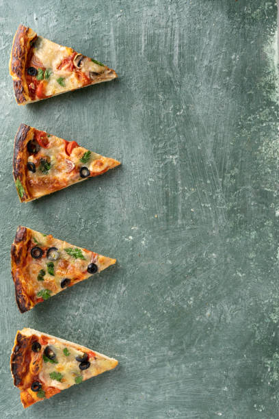 istock Several slices of pizza on a green background 1399205181