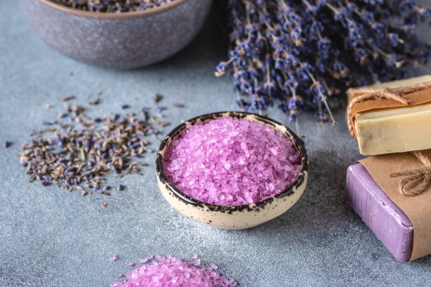istock Lavender sea salt and lavender soap. Spa products. Gray rustic background. Side view, selective focus. 1399207431