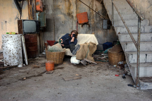 Homeless Young Adult Man Desperation Crisis Homeless Desperate Young Adult Man Living in an Abandoned Building Underground tramp home stock pictures, royalty-free photos & images