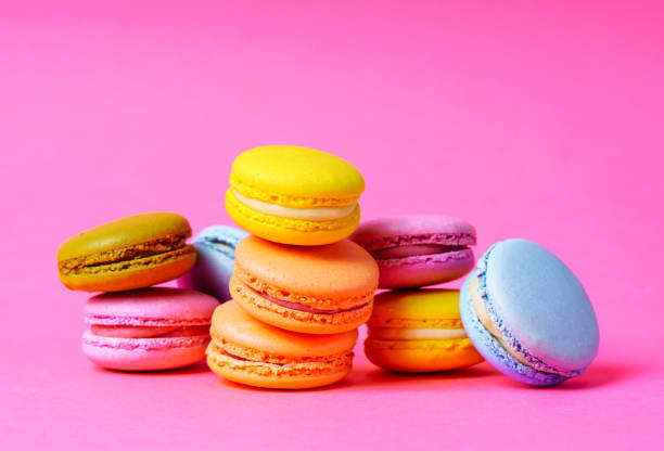 istock Colorful french macarons on a pink background. 1399208464