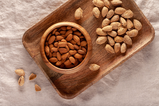 Close-up of almonds in a wooden bowl on the table