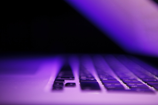 Laptop in purple lighting