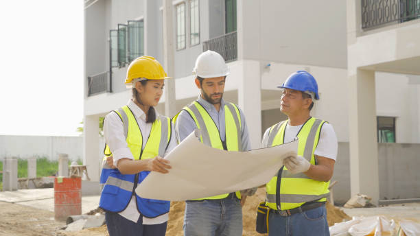 istock A group of workers, a designer team talk, communicate, discuss, and working on industrial construction site at home architecture building project. People lifestyle. 1399211621