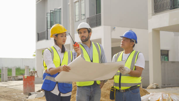 istock A group of workers, a designer team talk, communicate, discuss, and working on industrial construction site at home architecture building project. People lifestyle. 1399211734