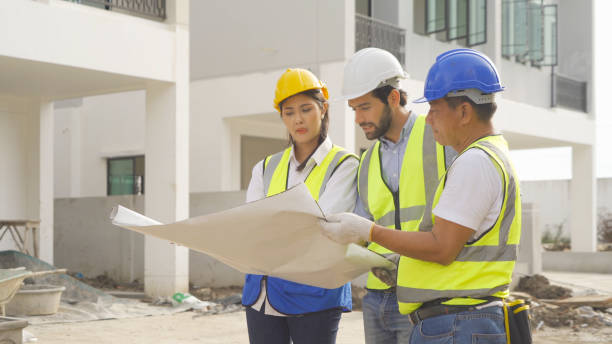 istock A group of workers, a designer team talk, communicate, discuss, and working on industrial construction site at home architecture building project. People lifestyle. 1399211742