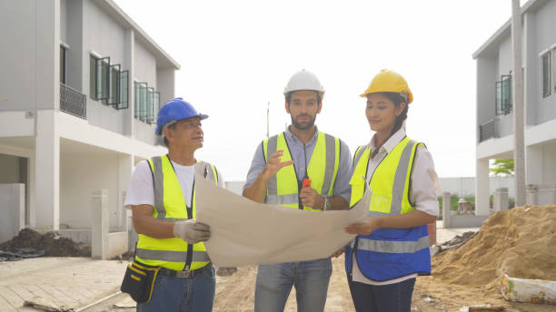 istock A group of workers, a designer team talk, communicate, discuss, and working on industrial construction site at home architecture building project. People lifestyle. 1399211992