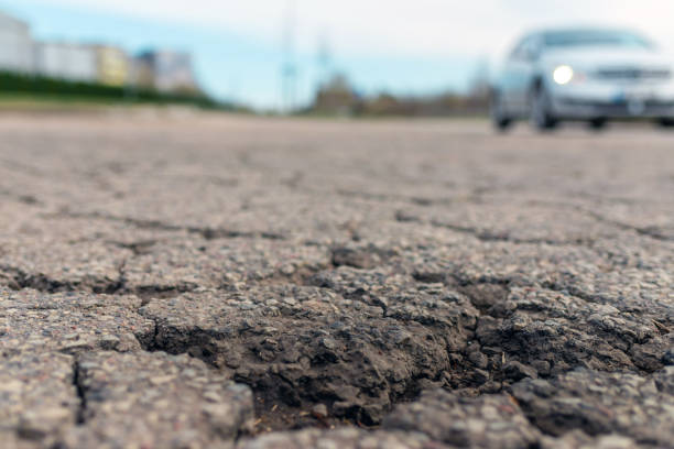 istock Empty damaged alphalt road in the street.Blurred blue sky,car background. 1399212211