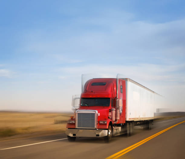 istock Refrigerated red semi trailer transporting commercial cargo - panning motion blur 1399213255