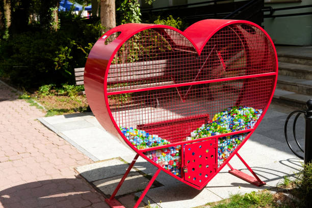 istock heart shaped container for recycled plastic bottle caps collected for charity 1399213585