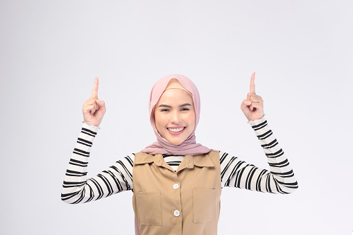 A portrait of beautiful woman with hijab is smiling on white background