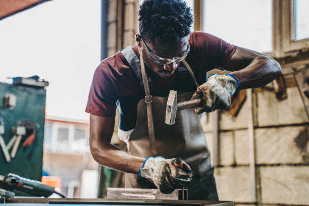 istock Industrial welder working with hammer and chisel 1399216583