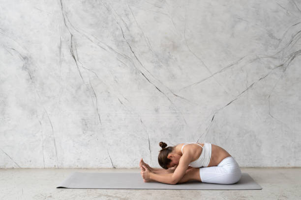 istock Young flexible woman practicing yoga left seated forward bend, paschimottanasana 1399218194