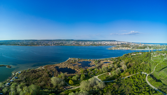 Bird's eye view panorama of the modern historic small town of Sozopol with a variety of cozy seaside houses and small sea spring boats, near the calm deep rippled Black Sea