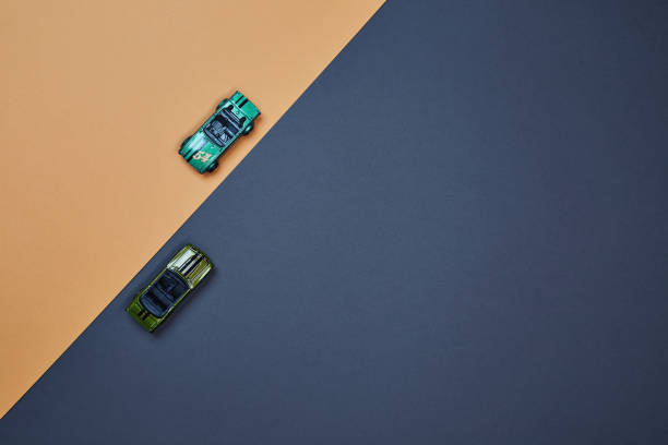 istock Two micro toy small mini cars opposite direction top view 1399218398