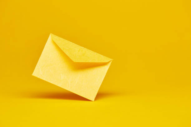 istock Yellow office envelope for greeting or invitation on the yellow background 1399218651