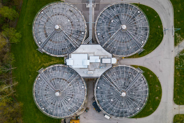 istock Modern urban wastewater treatment plant. Water purification plant, automatic process of removing chemicals, solids and gases from contaminated water. Water cleaning facility outdoors. Aerial view. 1399219573