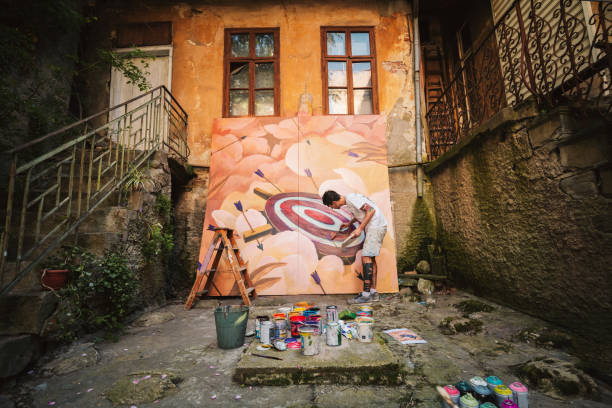 istock Male artist working on a big painting. 1399219903