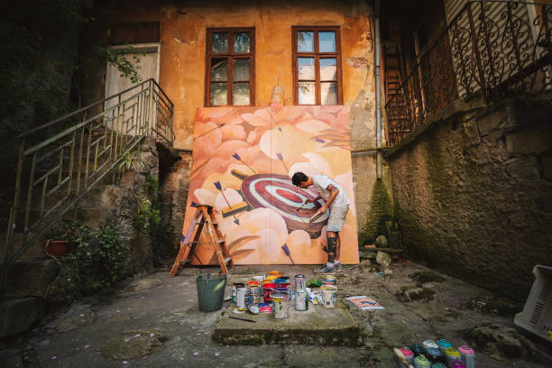istock Male artist working on a big painting. 1399219904