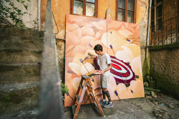 istock Male artist working on a big painting. 1399219909