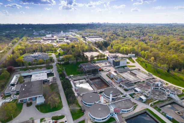 istock Modern urban wastewater treatment plant. Water purification plant, automatic process of removing chemicals, solids and gases from contaminated water. Water cleaning facility outdoors. Aerial view. 1399220021