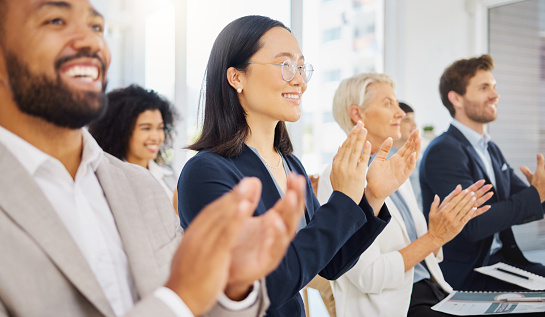 Shot of a group of businesspeople clapping during a conference