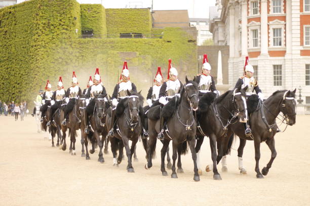 London, United Kingdom - June, 13th 2006:Mounted Horse guards parade through London beneath British flags in a ceremonial parade