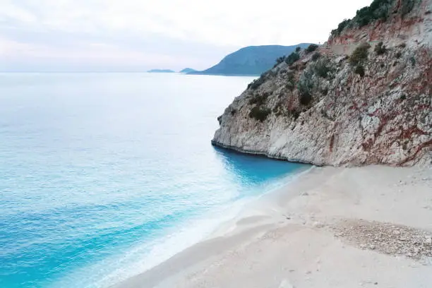 Beautiful sandy beach with white sand Kaputas in Turkey,Kas.View from top, no people.Sunset time in spring.Copy space.
