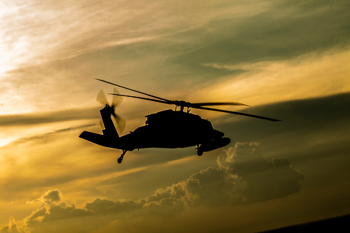 helicopter returning from training mission at sunset