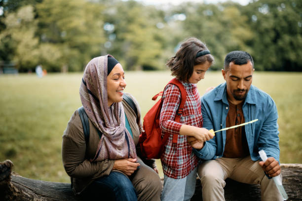 istock Middle Eastern family using bubble wand while spending a day in the park. 1399232231