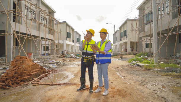 istock A group of workers, a designer team talk, communicate, discuss, and working on industrial construction site at home architecture building project. People lifestyle. 1399232294