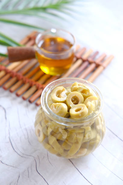 istock bottle of olive oil and fresh olive in a container on table . 1399236034