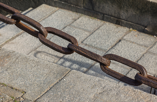 Close up view of old vintage iron chain at historical place. Sweden. Stockholm.