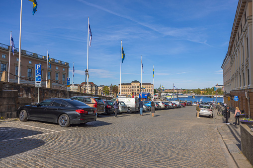 Sweden. Stockholm. 05.18.2022. Beautiful view of Swedish and Finnish flags on waterfront in downtown Stockholm.