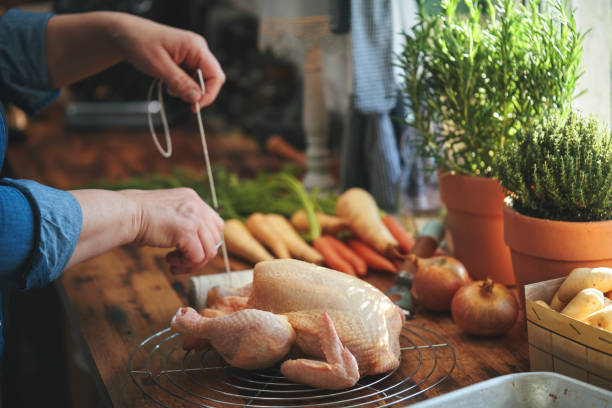 istock Preparing Roasted Chicken with Root Vegetables in Domestic Kitchen 1399238164