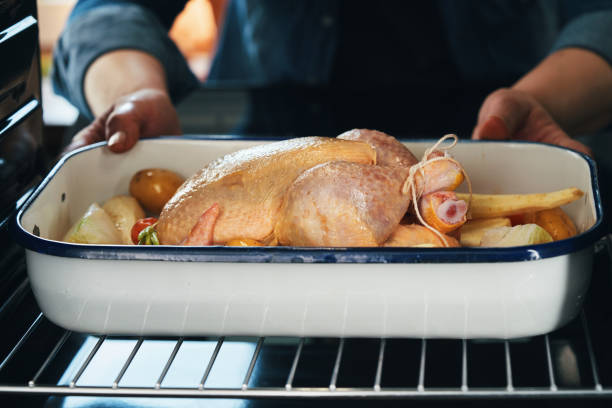 istock Preparing Roasted Chicken with Root Vegetables in Domestic Kitchen 1399238193