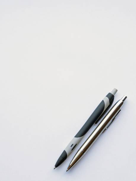 istock a sheet of white writing paper and two pens 1399238234