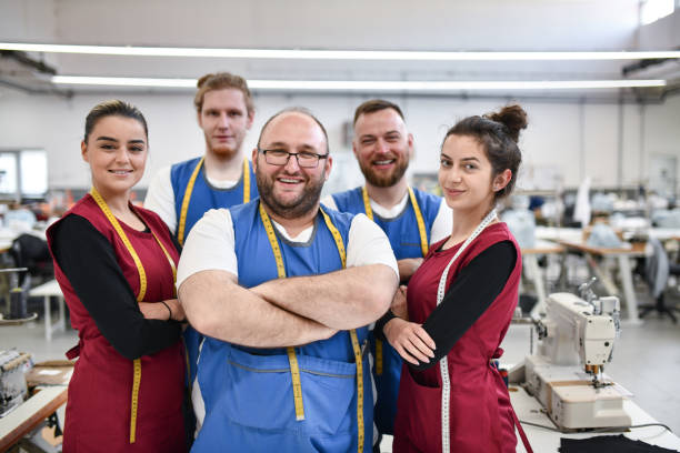 istock Smiling Textile Factory Team At Their Work Place 1399239636